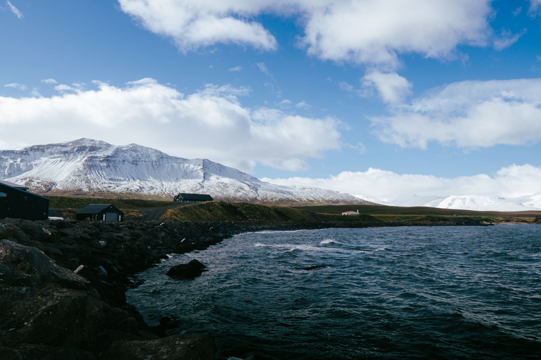 Moody coastal cliff with black volcanic beach in East Iceland